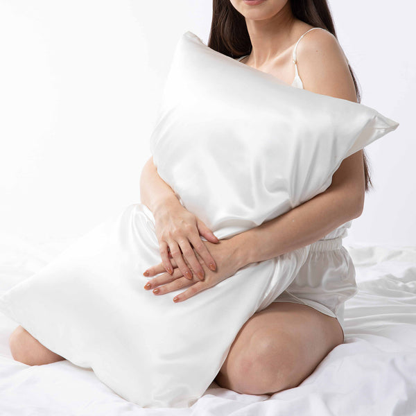 Lady holding white  mulberry silk pillowcase.